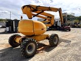 a yellow crane that is sitting in the dirt