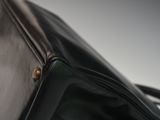a close up of a black purse on a table