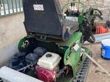 a lawn mower that is sitting on the side of a building