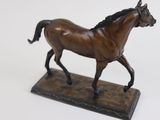 a statue of a horse that is standing on a base