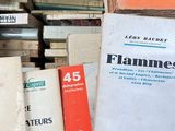 many books stacked on top of each other on a table