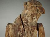 a wooden statue of a man with a tie on