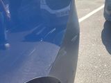 a close up of a car ' s bumper with a hole in it