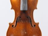 an old violin with a bow hanging from it ' s back