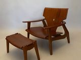 an image of a chair and ottoman in a room with a white wall