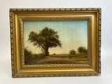 une peinture à l'huile représentant un arbre sur un chemin de terre, dans un cadre doré