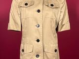 an image of a women ' s jacket on a mannequin stand