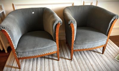two chairs sitting next to each other on a rug