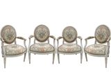 a set of three chairs with floral upholstered cushions