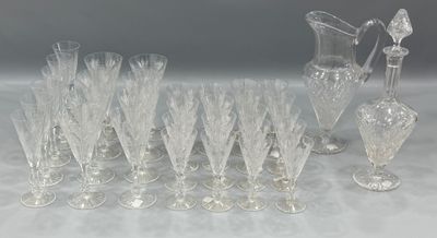 a lot of wine glasses and a pitcher on the table