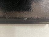 a close up of a black purse on a table