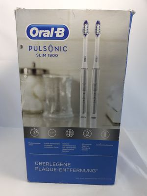 packaging of two toothbrushes in a box on a white surface