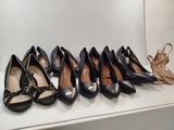 several pairs of women ' s shoes are lined up on a shelf