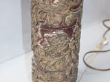 a vase that is sitting on a table next to a lamp