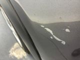 a close up of a car ' s paint on the side of the road