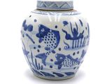 a blue and white vase with a lid on a white surface