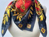 scarf on a mannequin torso with a red and yellow design