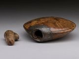 a wooden object that is sitting next to a piece of wood