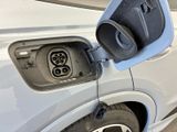 an electric vehicle plugged in to a charging station in a parking lot