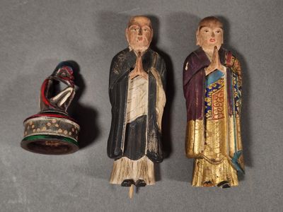two figurines of a man and a woman are sitting next to each other