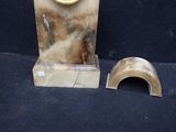 a clock that is sitting on top of a marble stand