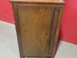 a small wooden cabinet with a door on the side
