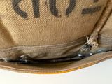 a close up of a bag with a pair of scissors in it