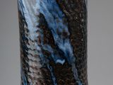a close up of a vase with a blue and brown design