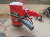 a red machine that is sitting on the floor