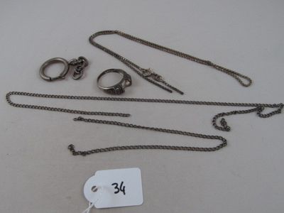 a lot of silver jewelry on a table with a price tag