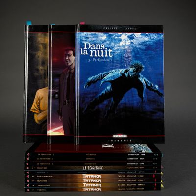 books stacked on top of each other on a black surface