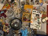 a box full of assorted jewelry on a table
