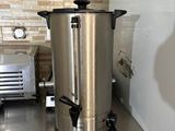 a coffee pot sitting on top of a stainless steel counter