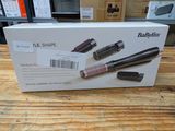 a box with three different types of hair brushes on a table