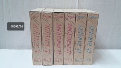 three books in a box on a table with a white background