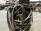 une machine recouverte d'un enchevêtrement de fils, dans un entrepôt