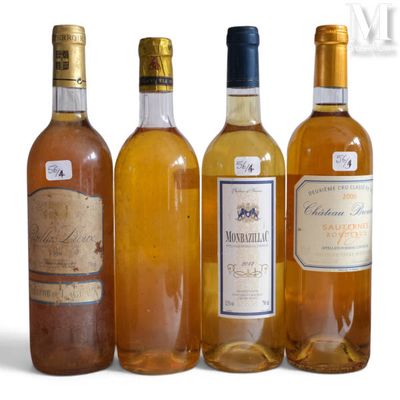 several bottles of wine are lined up on a white surface