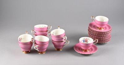 a lot of pink cups and saucers sitting on a table