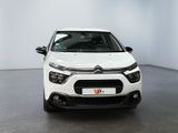 the front view of a white citrole parked in a white room