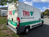 an image of a tms van parked on the side of the road