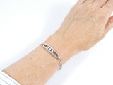 someone is wearing a bracelet that has a name engraved on it