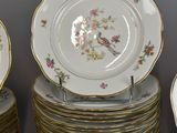 a lot of plates and cups and saucers on the table