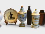 many vases and plates that are lined up on the table