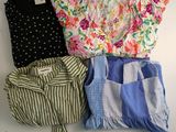 three shirts and shorts are laid out on a white surface