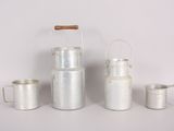three silver metal containers and a wooden handle on a white surface