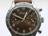 a close up of a wrist watch with a brown dial