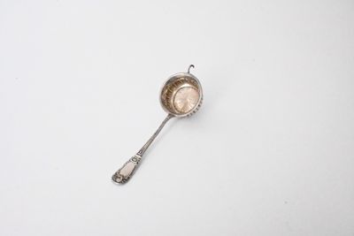 a spoon that is sitting on a white surface