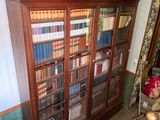 a book case with many books on it in a room