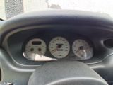 a picture of a dashboard of a car with gauges and speedometers