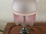 a lamp that is sitting on a table with a cord